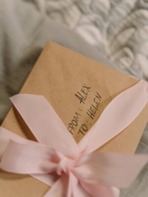 A beautifully wrapped gift box with a pink ribbon, perfect for special occasions.