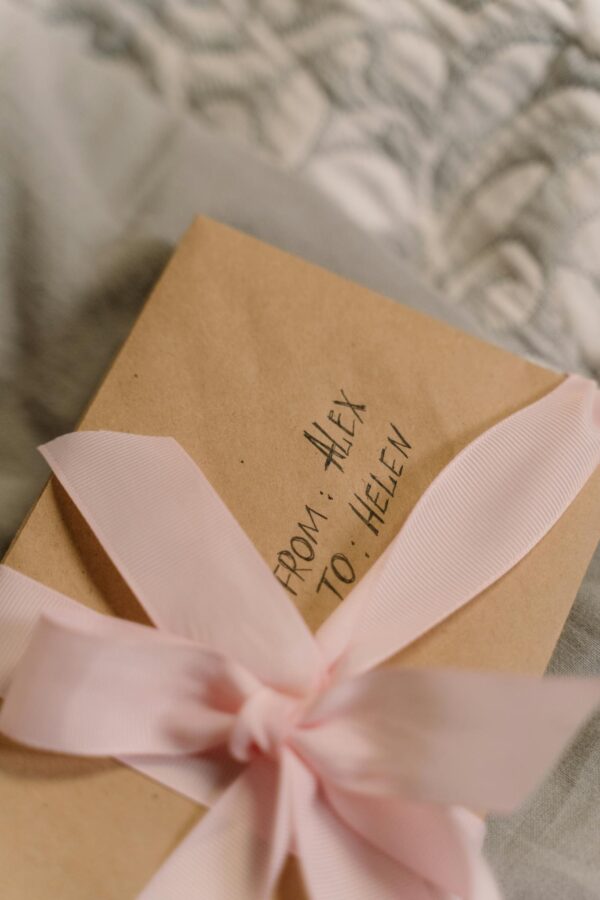 A beautifully wrapped gift box with a pink ribbon, perfect for special occasions.